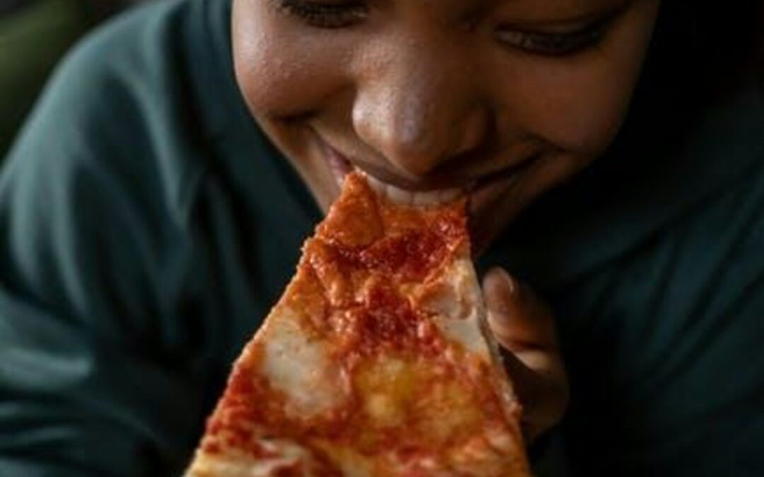 person eating a pizza delivered in las vegas